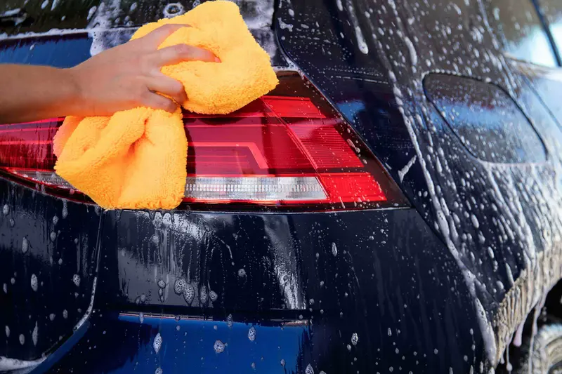 Close-up view of professional car care washing showing meticulous attention to detail and premium service quality
